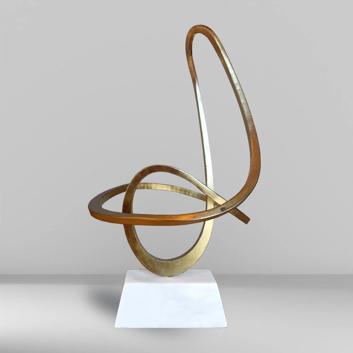 Gold sinuous metal sculpture by FP Art